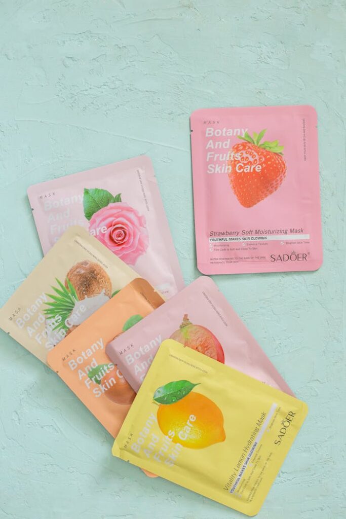 Collection of vibrant botanical and fruit-themed face masks for skincare.